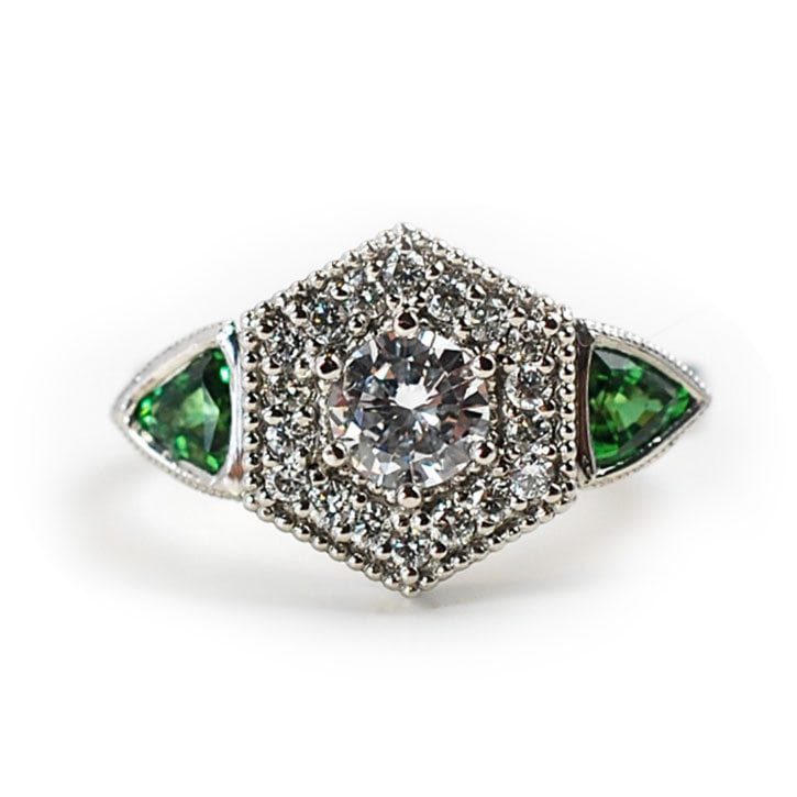 Custom engagement ring made with 0.4 carat center diamond, 0.38 ctw diamond halo, and 0.48 ctw tsavorite garnets custom made and designed by Abby Sparks Jewelry, The Stephanie.
