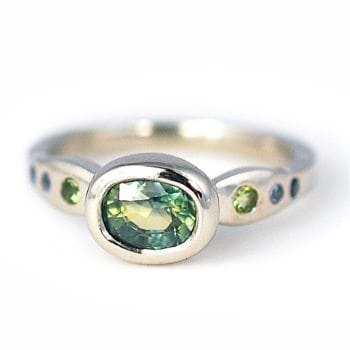 Custom engagement ring made with palladium, 1.18 carat aqua sapphire, peridot, and blue sapphire accents custom made and designed by Abby Sparks Jewelry, The Sierra.