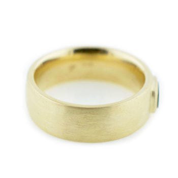 Side profile and details of The Matt, a men’s wedding ring made with 14k yellow gold, 0.58 carat custom cut river rock, and matte finish custom made by Abby Sparks Jewelry.